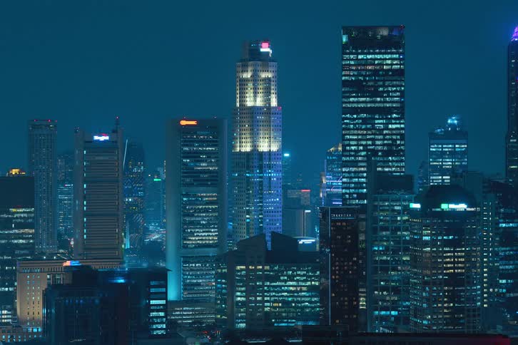 Illuminated skyscrapers at night in metropolitan cities