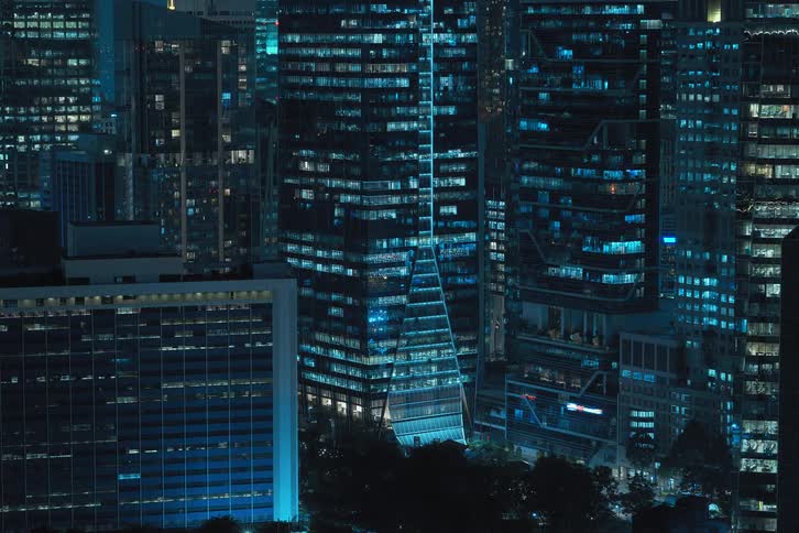 View of buildings in a metropolis at night in time lapse with lights pulsing and flashing
