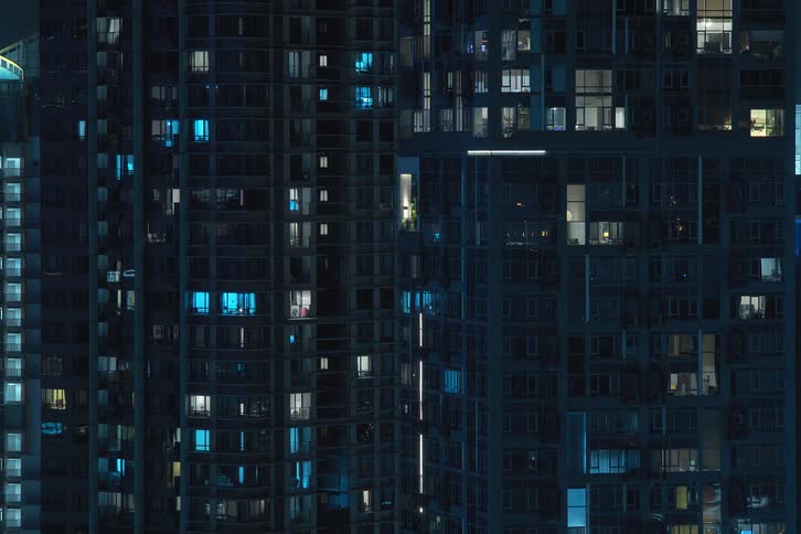 Several highrise apartments with lights turning on and off quickly