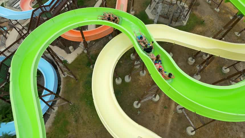 People ride on tubes down a waterslide