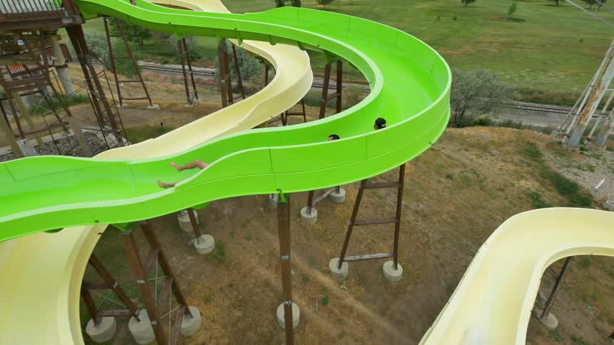 People use a slide in an amusement park