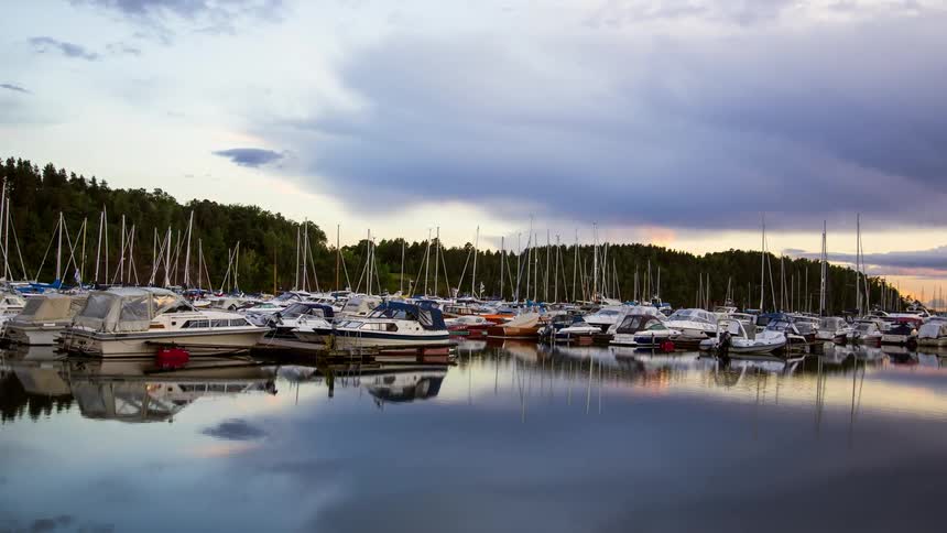 A row of boats docked in a harbor bobbing gently in the water providing a sense of peace and tranquility