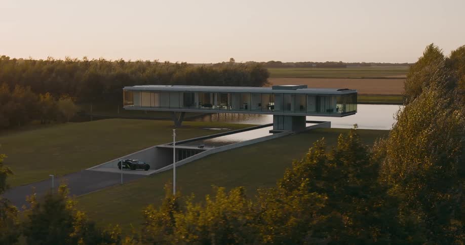 Abstract modern home with glass walls reflecting pond and underground garage entrance in the middle of farmland at sunset