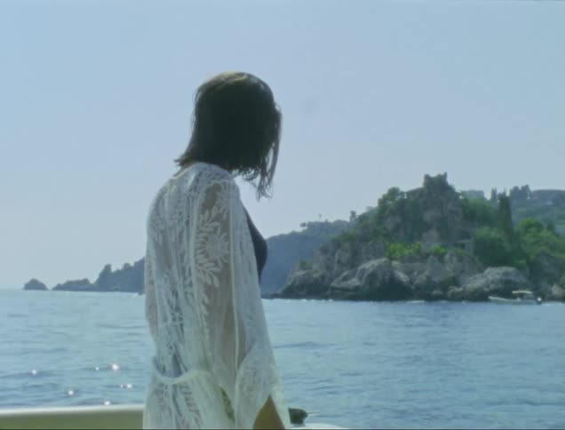 Woman on a boat in the middle of the sea enjoying the view