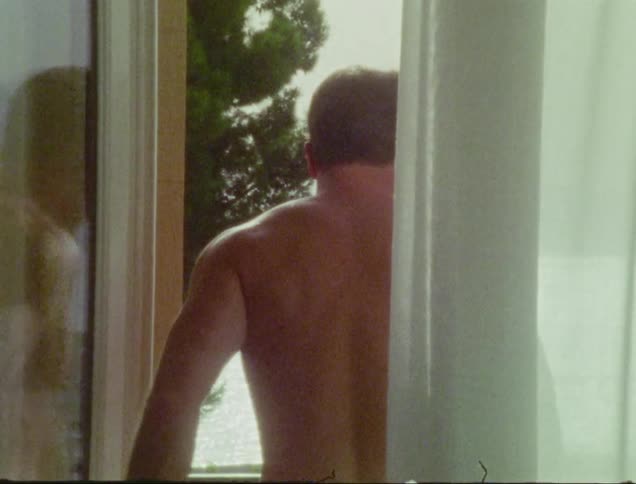 A man walks on his terrace facing the ocean