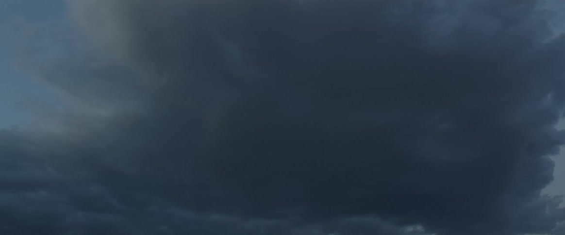 Dark storm clouds hang over the mountains