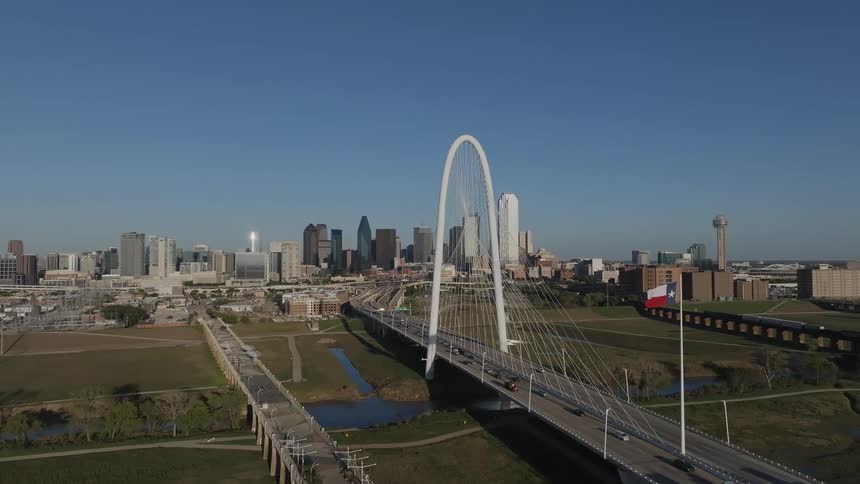 A bridge in a city with several cars passing over it