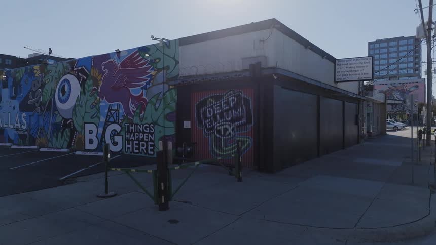 A store in the city with a wall with street art