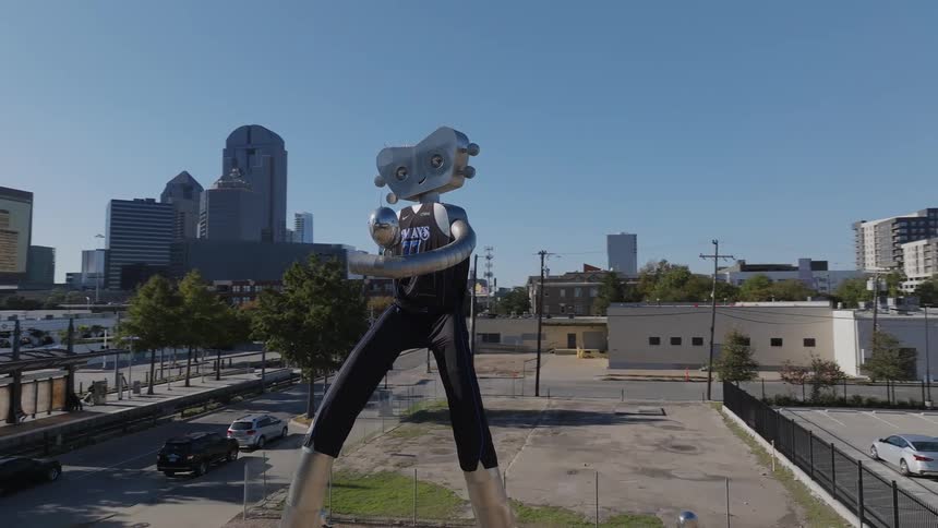 Aerial view of public art hammering man and city skyline