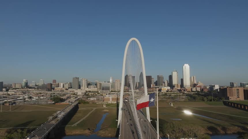 Panorama of an arch on a bridge with a metropolis in the background
