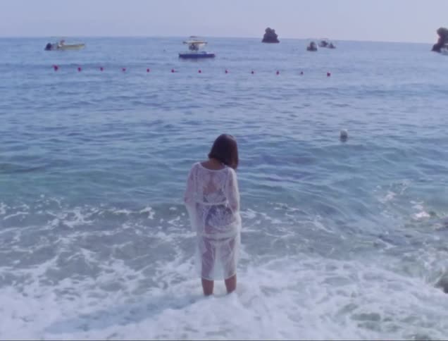 Woman wetting her legs at the seashore