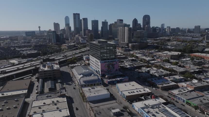 Aerial view of an office building with a graffiti wall near highways in the city