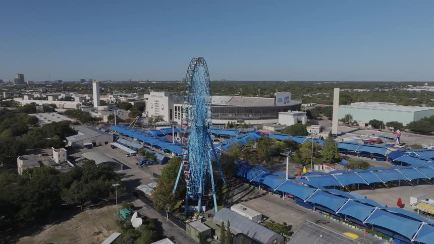 Skyline of a ferris wheel in an amusement park in a city
