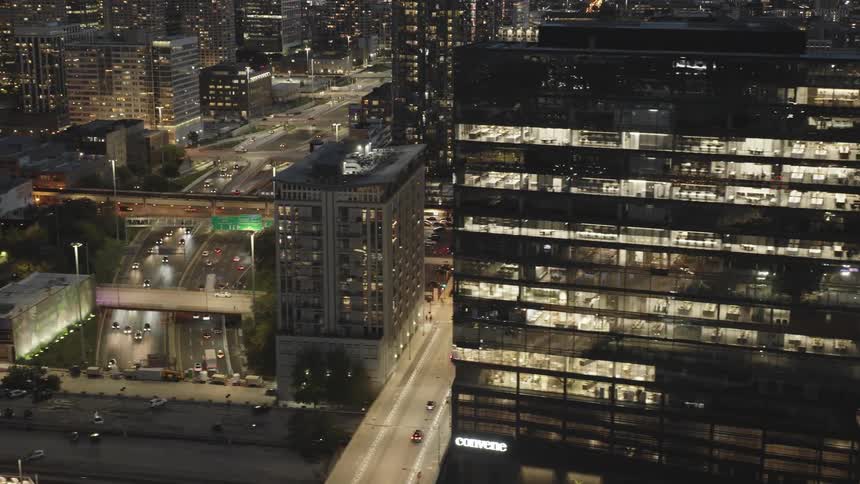 Traffic runs through the brightly lit city at night
