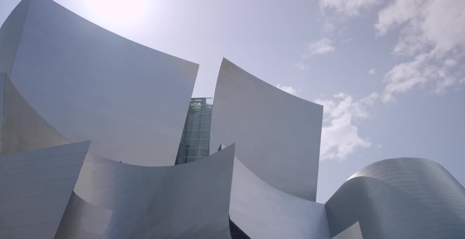The sun shines over a modern looking building