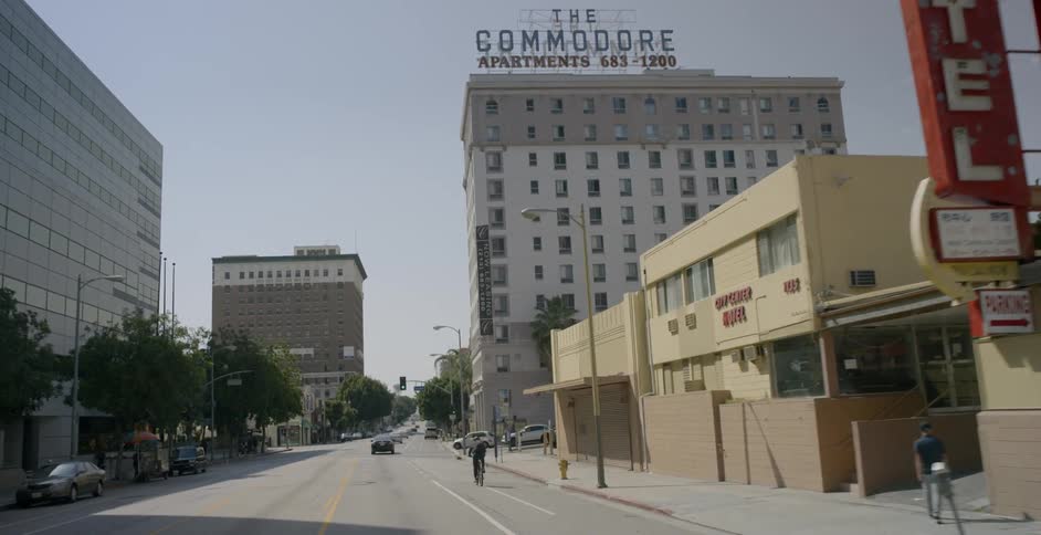 A vehicle drives down a city street