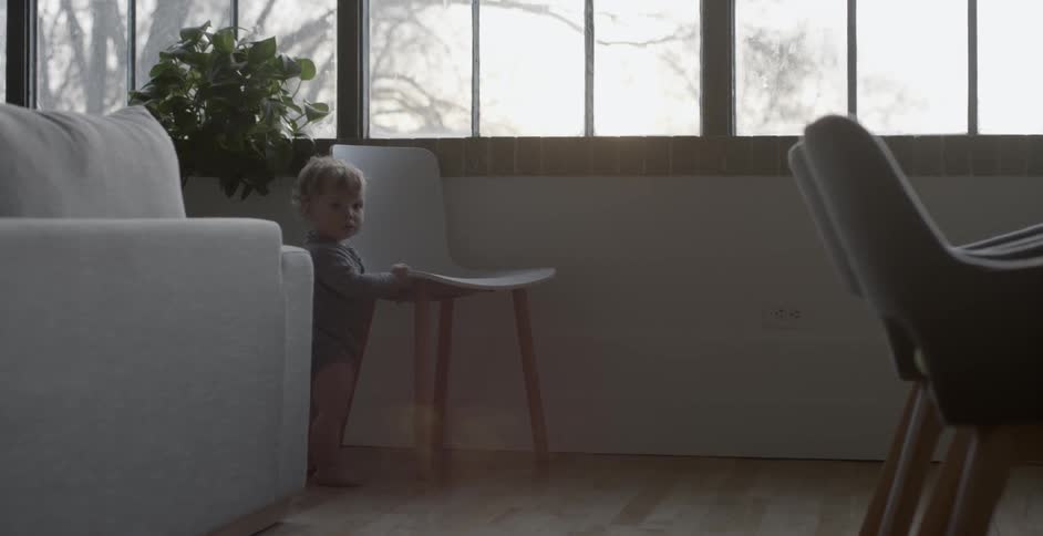 A child is standing by the window