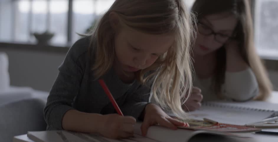 A girl and woman are drawing