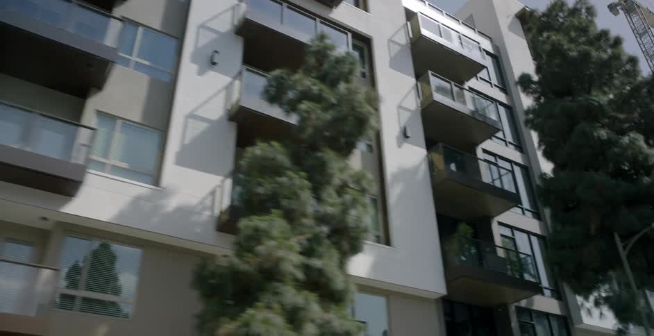 An apartment building towers overhead