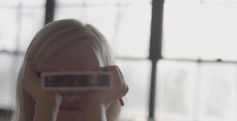 A girl looks through a box