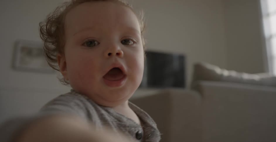 A baby is waving its hand forward
