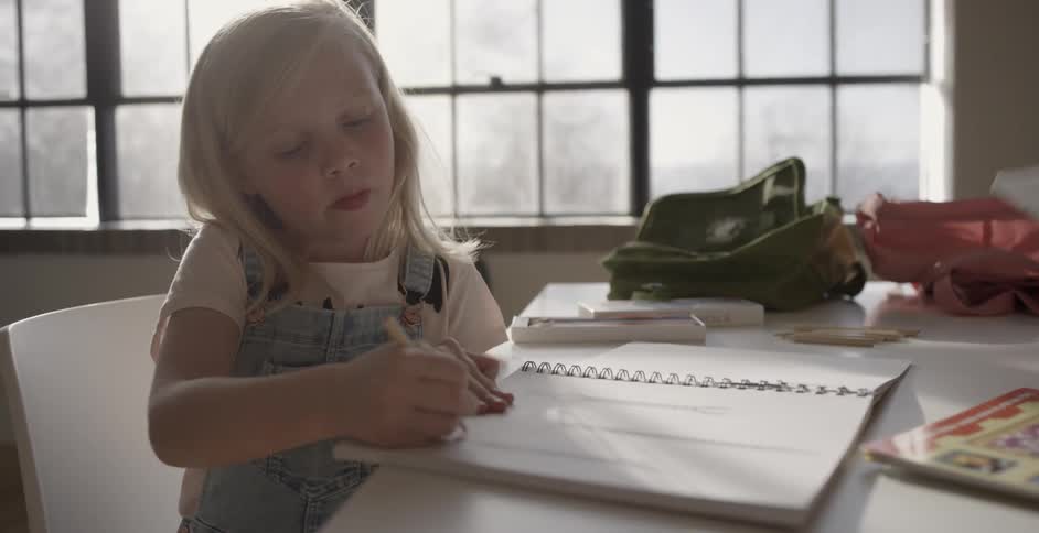 A girl is writing in a notebook