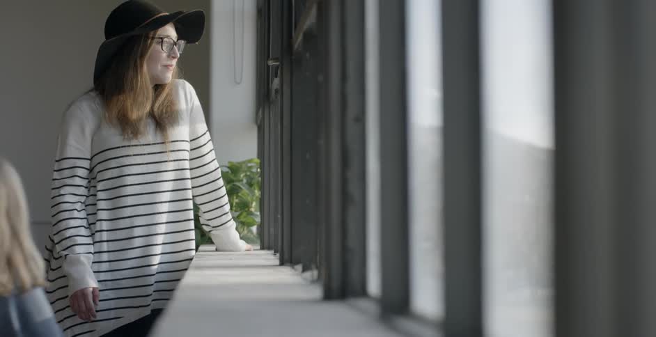A child walks up to a woman in a striped shirt