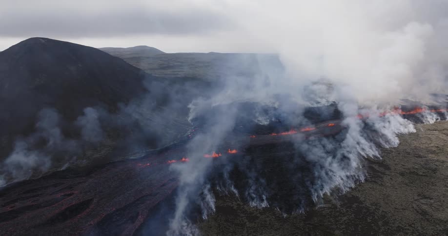 Smoke rises as flaming hot lava flows across the land
