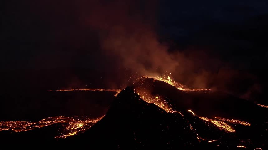 Erupting volcano during night time