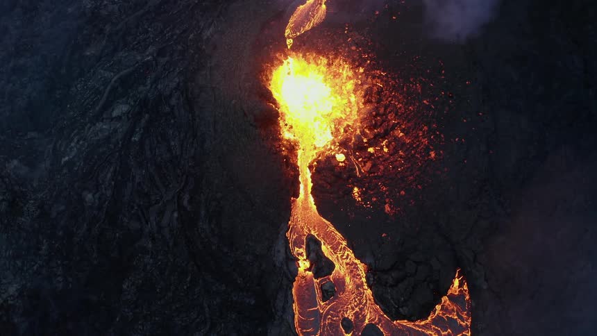 Smoke rises from erupting volcano covered in ash