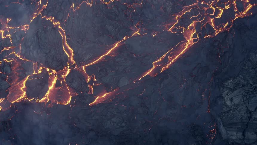 Textures of molten hot lava as it flows down the side of an erupting volcano