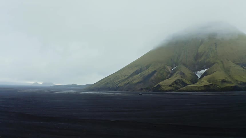 The volcano is covered with fog and green moss