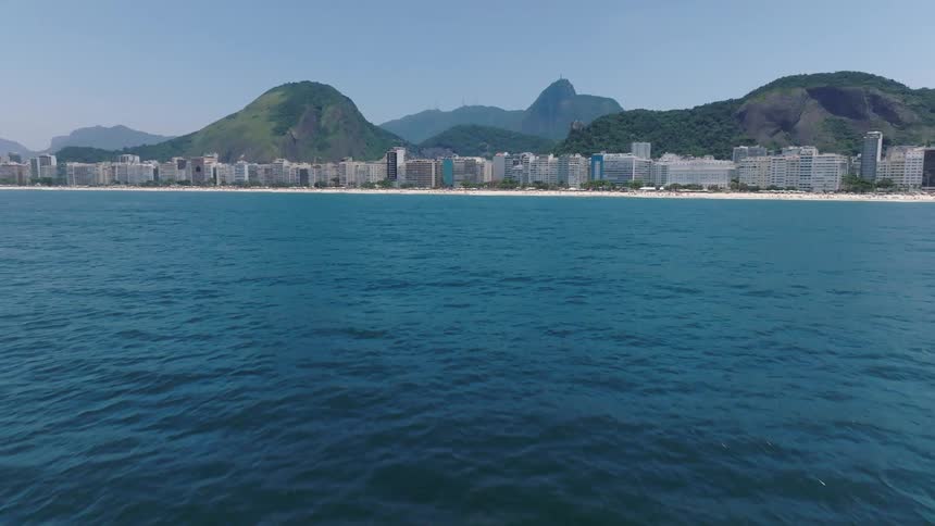 Aerial view oceanfront buildings mountain on horizon