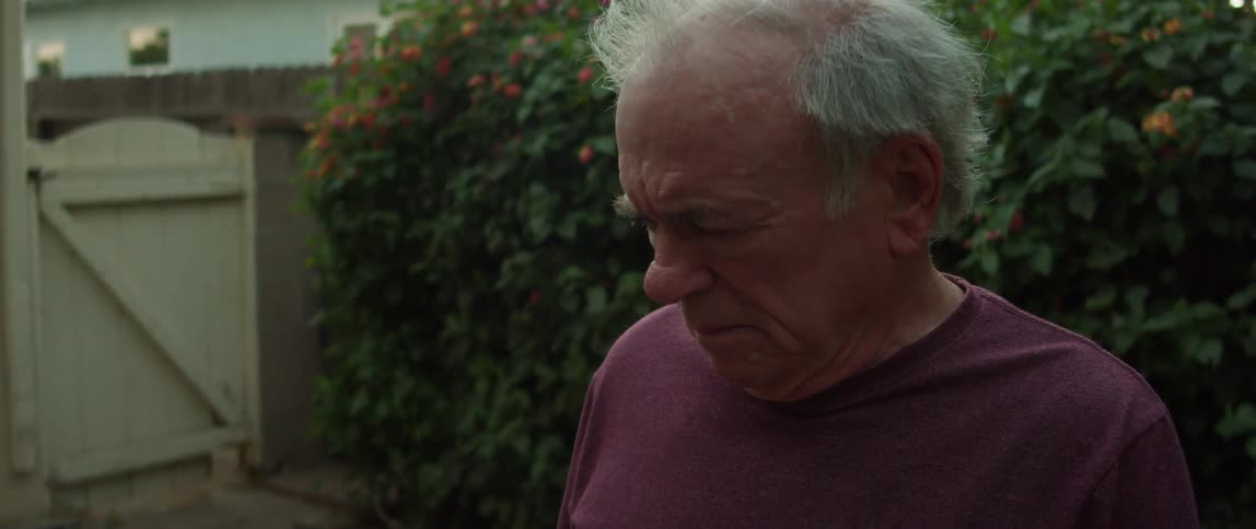 A sad old man in his yard