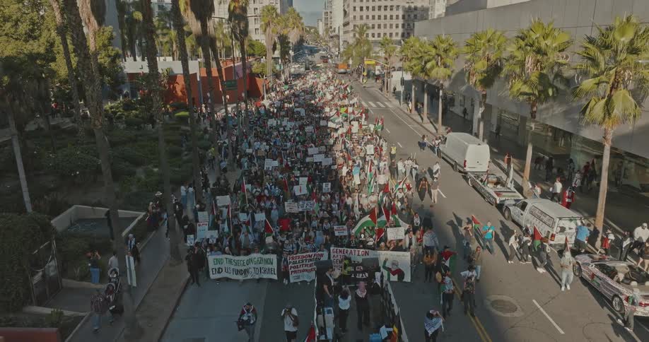 Crowd of people marching on the city streets