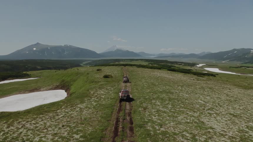Vehicles on a dirt road in nature during winter