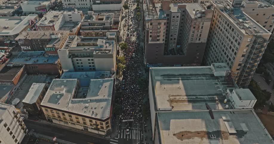 Aerial panorama of a crowd of people walking through the city streets demonstrating