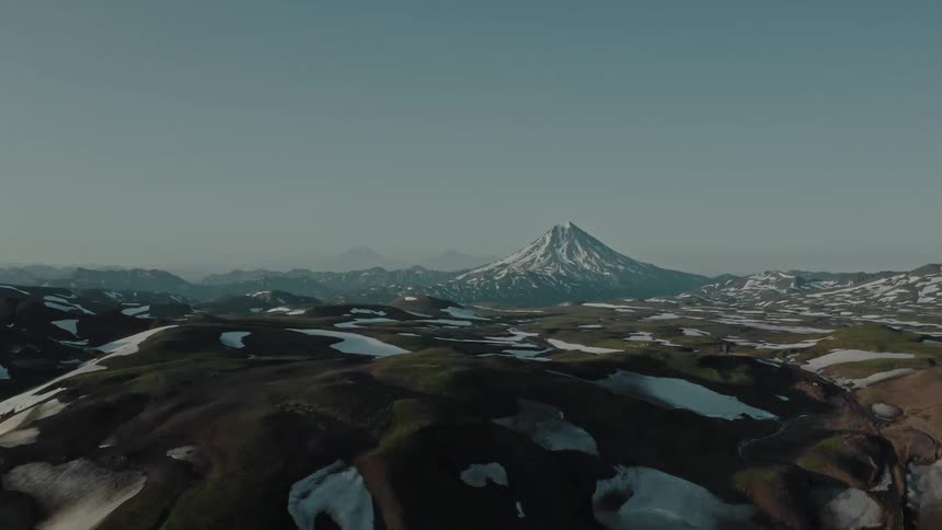 Aerial of snow melting on a plain during a sunny day