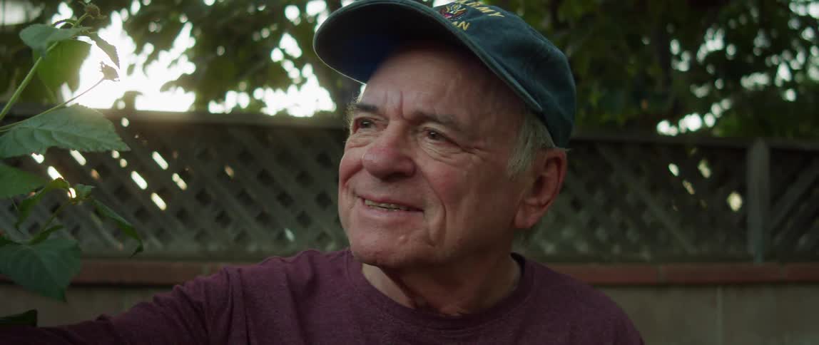 A happy man taking care of the plants in the garden