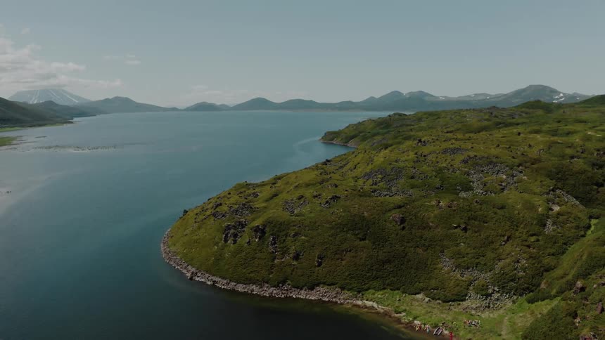Aerial view of the sea surrounded by coasts and mountains in the daylight