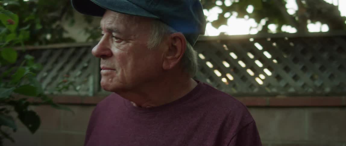 A man is standing in his yard