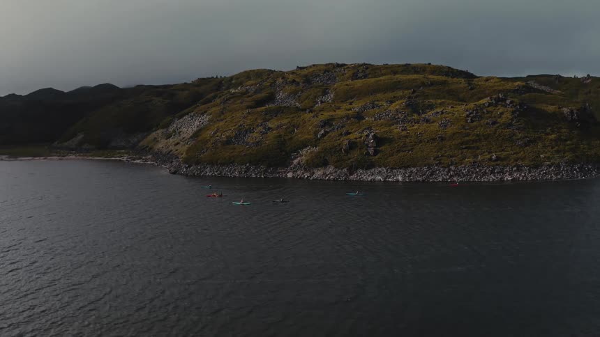 Aerial view of kayakers on a lake on the mountains