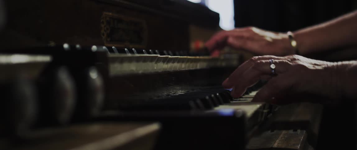 Someone playing organ indoor at night