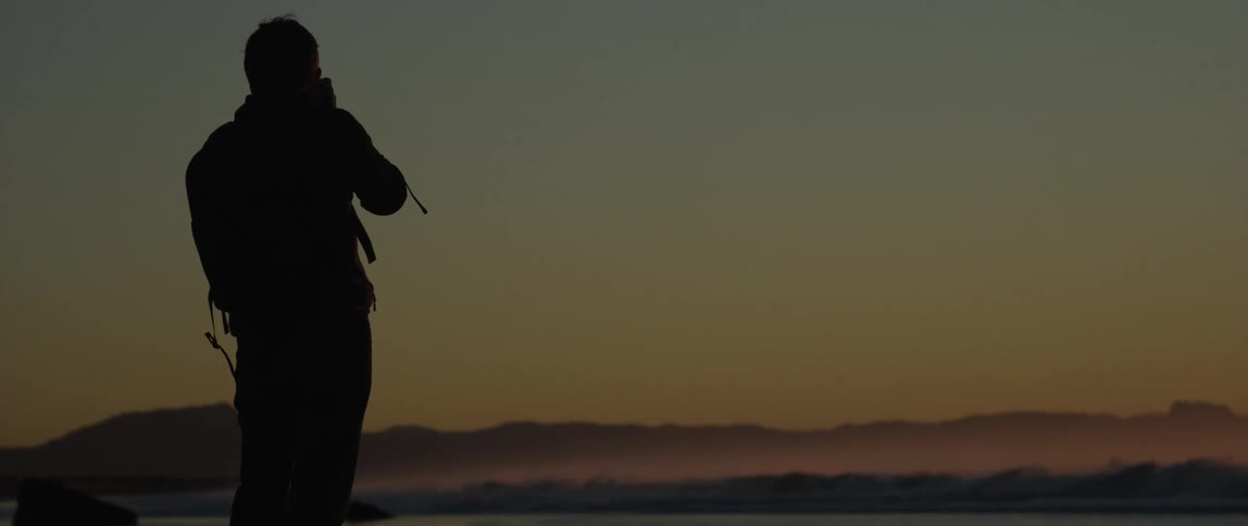 A man photographing the landscape at dusk