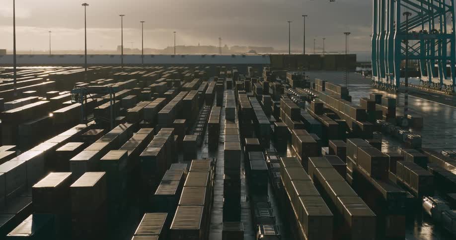Dock machine passes between containers on loading dock on a foggy day