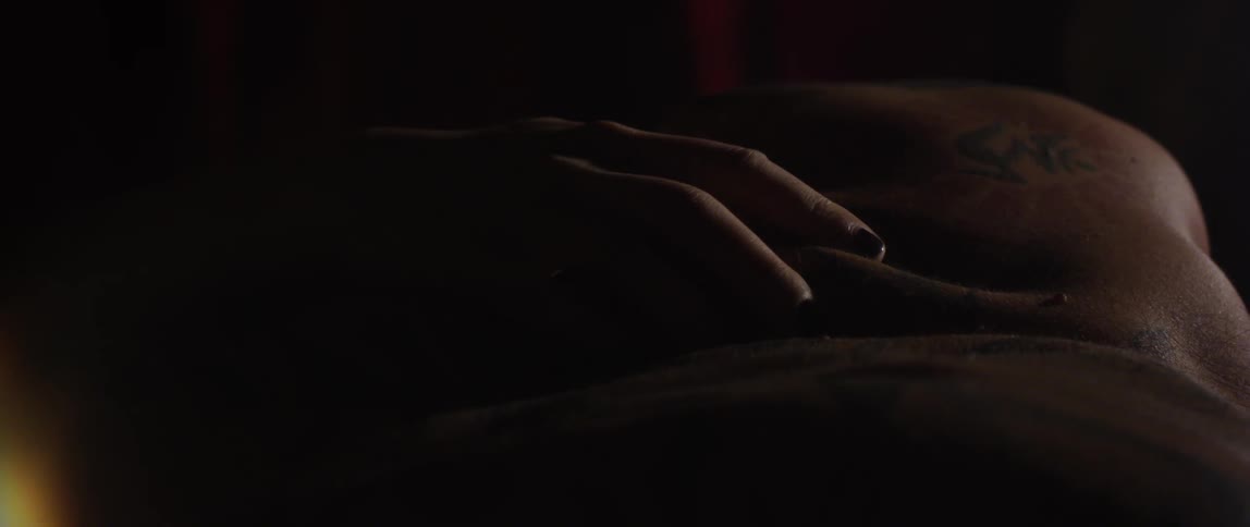 A person caressing another persons back