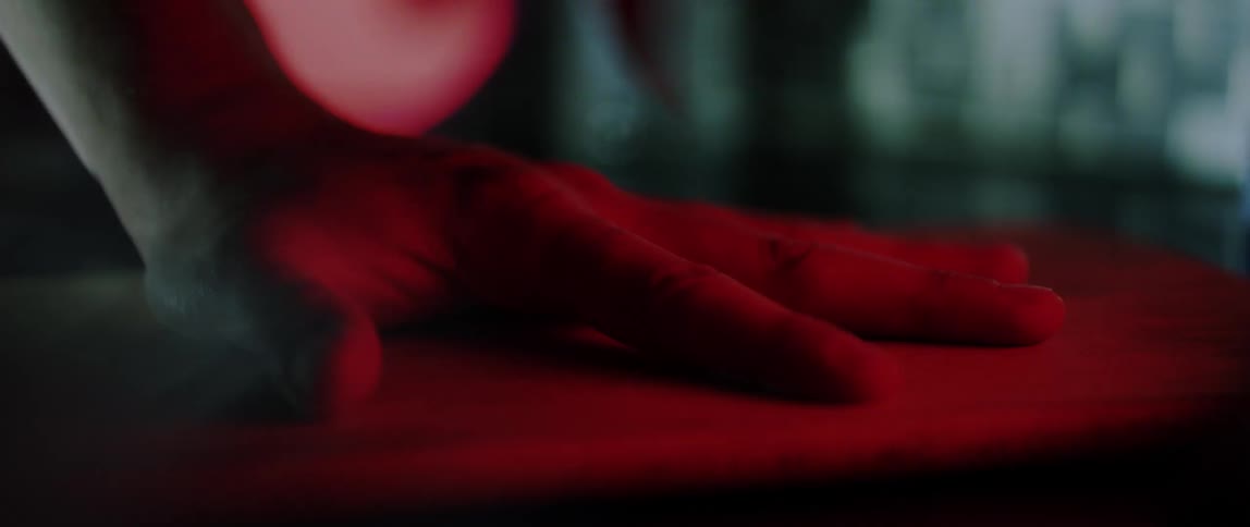 A person is stabbing between their fingers