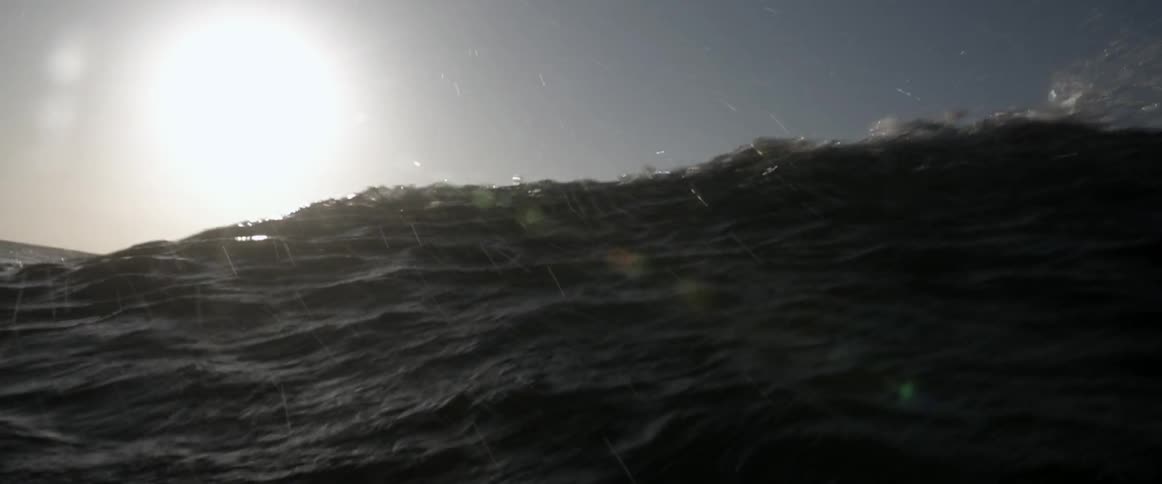 Waves crash on a cloudy day