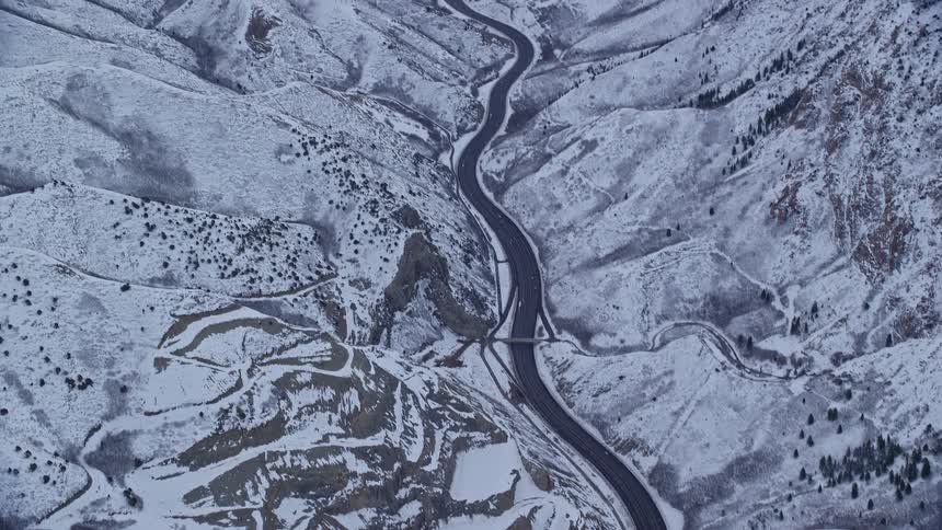 Winding road amidst a snowcovered mountain range
