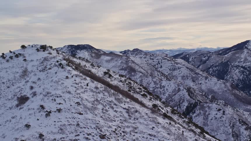 Aerial view of snow covered mountain peaks at morning